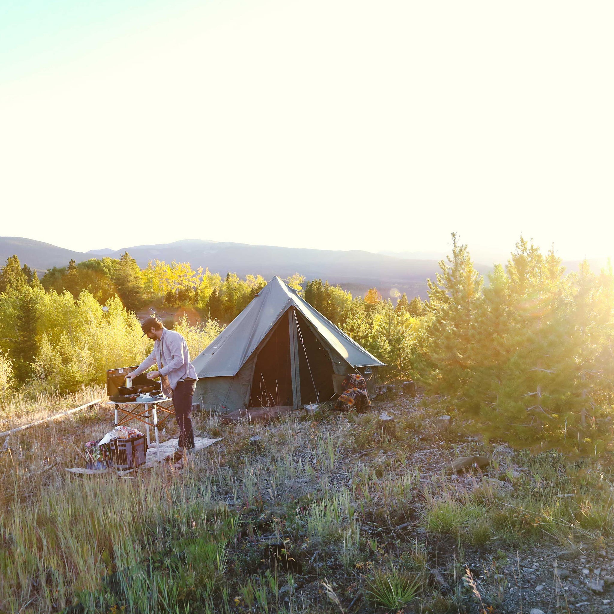 Regatta Bell Tent boulder grey with man cooking next to it