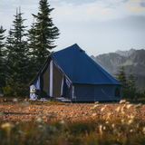 10' Regatta Bell Tent - Sapphire Blue placed in a forest setting with sunlight on it