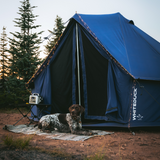 10' Regatta Bell Tent - Sapphire Blue in the forest with fairy lights and dog sitting in front