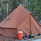 Regatta bell tent desert red with stove exhaust in forest