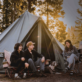 Regatta bell tent forest green with people sitting in front in forest