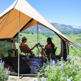 rover scout tent all opened up with mesh closed on the side walls, and a couple cheering to drinks sitting inside