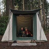 couple enjoying nature with their dog in a cabin tent