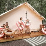 alpha wall tent set up on a platform with kids thoroughly enjoying 