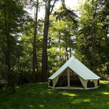 avalon bell tent fully set up in the grassland next to huge trees