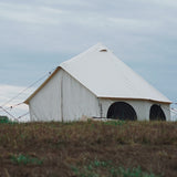 avalon bell tent set up in grasslands with all windows and doors closed