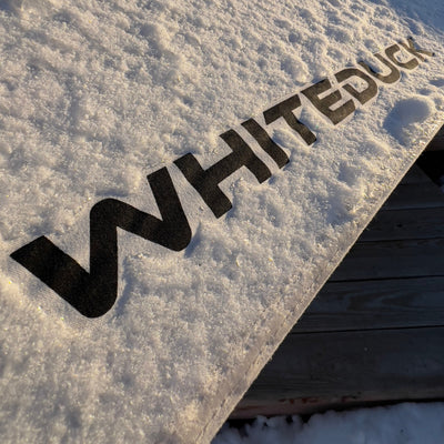 avalon bell tent in the snow with whiteduck logo