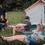 people camping with their alpha wall tent sitting outdoors 