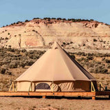 A regatta bell tent on a wooden platform in a desert with red rock formations