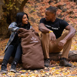 Hoplite Canvas Top Load Bag being used outdoors by a couple