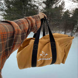 Hoplite Canvas Parachute Bag being held out in the snow